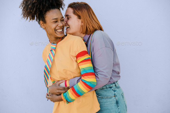 Happy Multiethnic Lesbian Couple Hugging And Laughing Stock Photo By